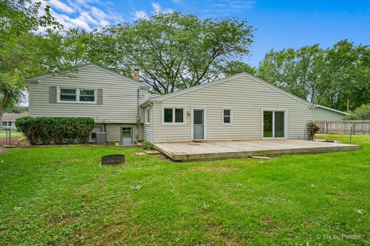 Rear exterior with a wood deck and a fenced back yard