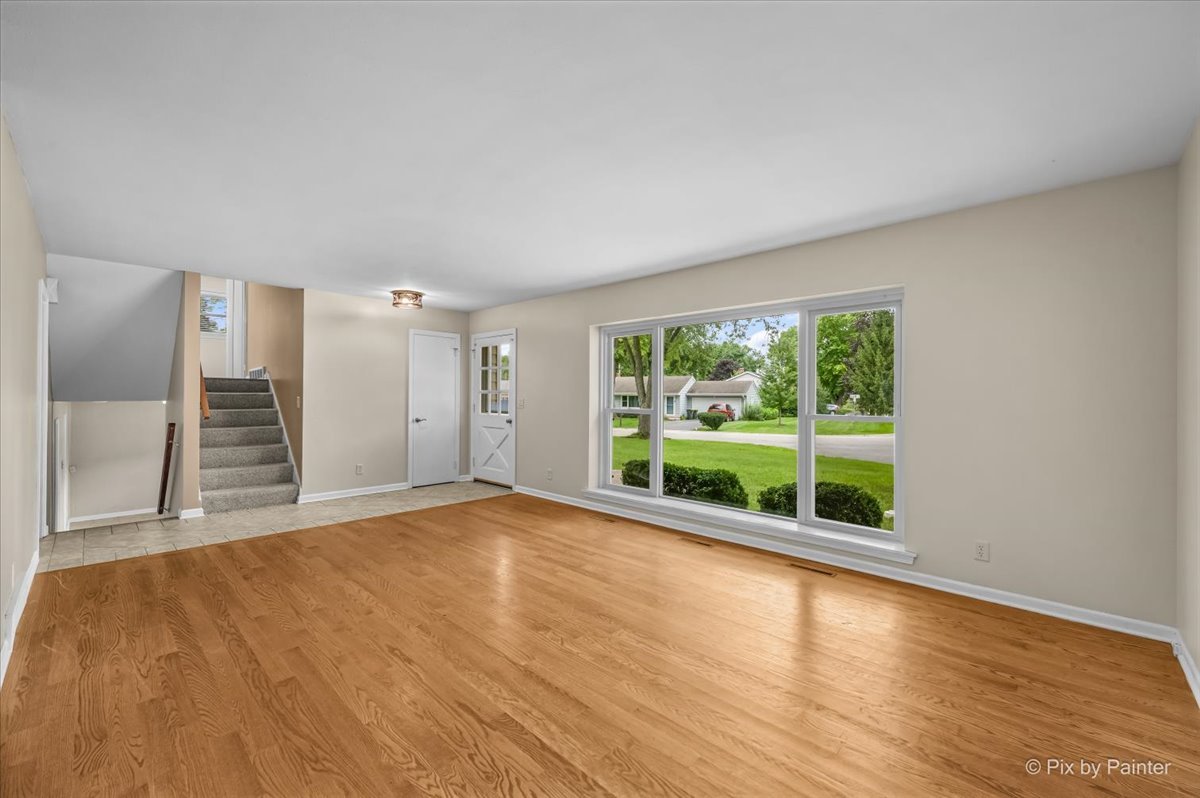 Living room looking toward the tiled entry and the stairs to the upper level