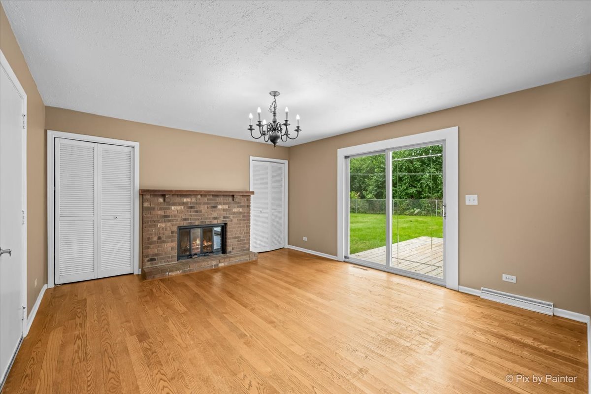 Lower-level family room with a brick fireplace and sliding doors to the deck